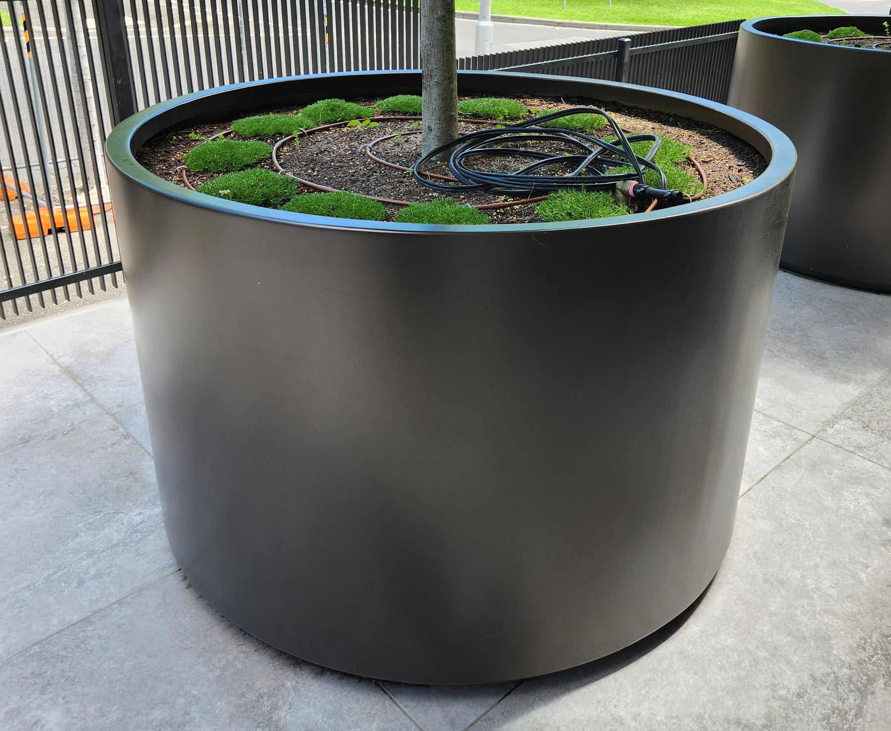 Sculptural aluminium cylinder planter as a feature object