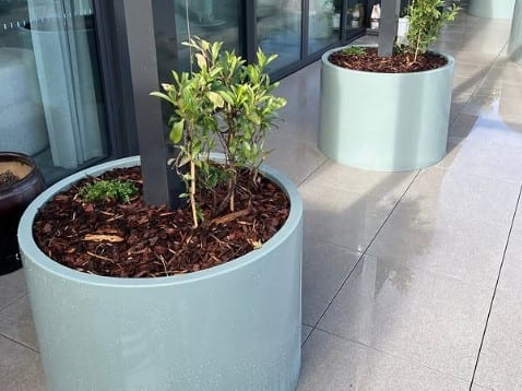 A cluster of grouped aluminium cylinder planters