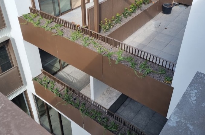 Balustrade-height POBOX planters forming a compliant edge on a terrace